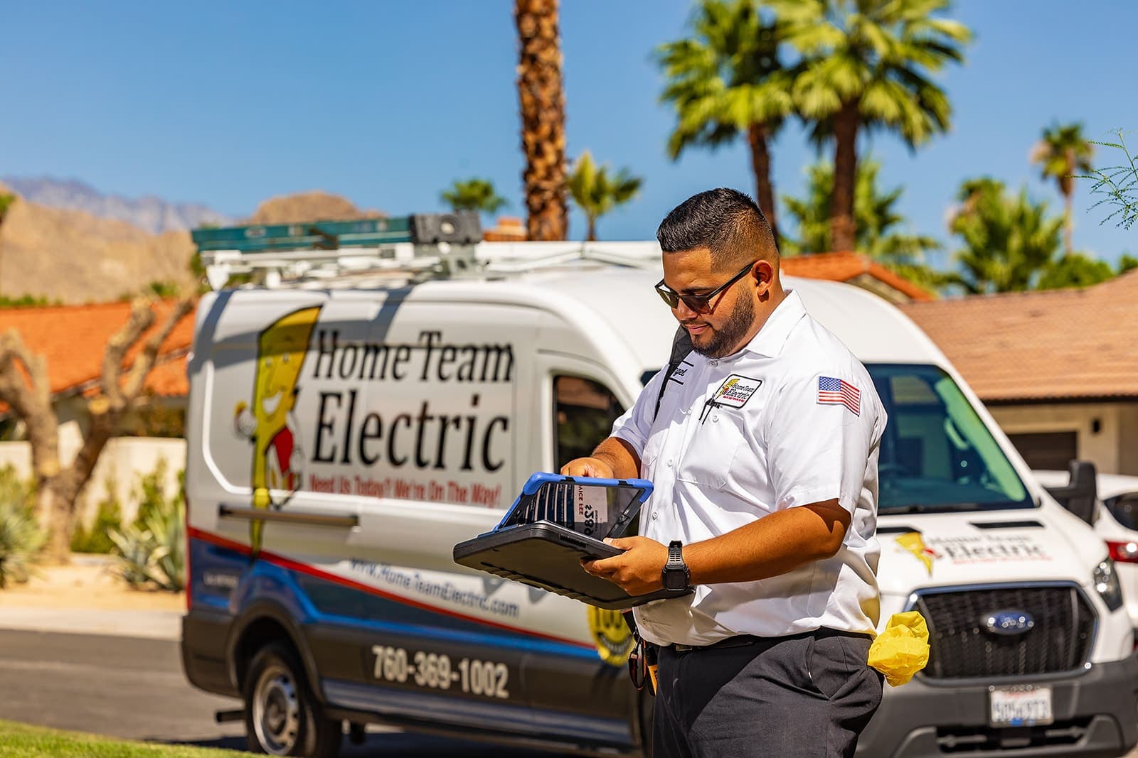 Home Team Electric electricians documenting panel and receptacle conditions during a whole-home assessment