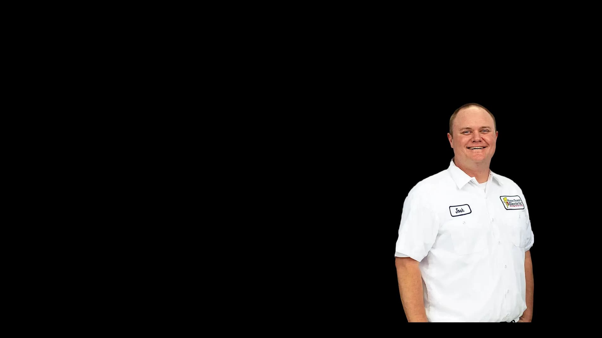Josh Randall, smiling Home Team Electric team member in a branded work shirt