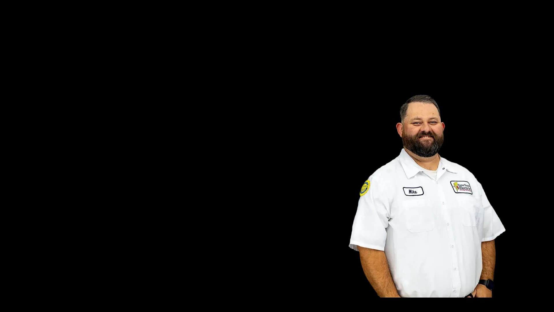 Mike Arganda, smiling Home Team Electric team member in a branded work shirt