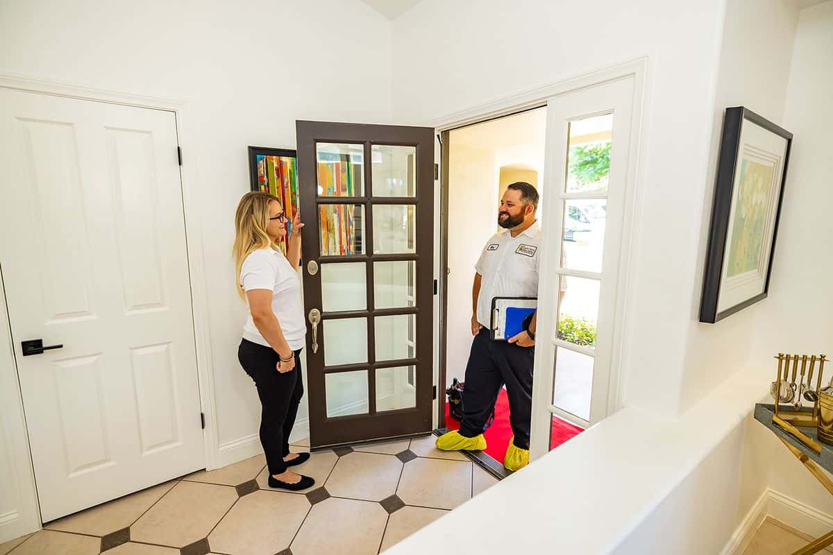 Home Team Electric electrician greeting homeowner providing friendly service